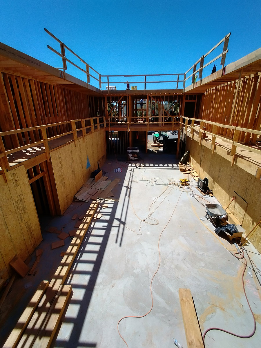 A team of engineers and construction workers from General Engineering Contractors retrofitting a soft-story building to improve its seismic resistance.