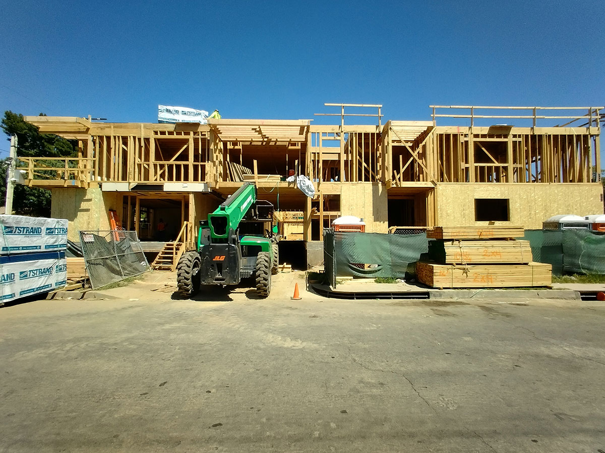 Tilt-up construction in progress, with large precast concrete wall panels being lifted and secured into place by General Engineering Contractors.
